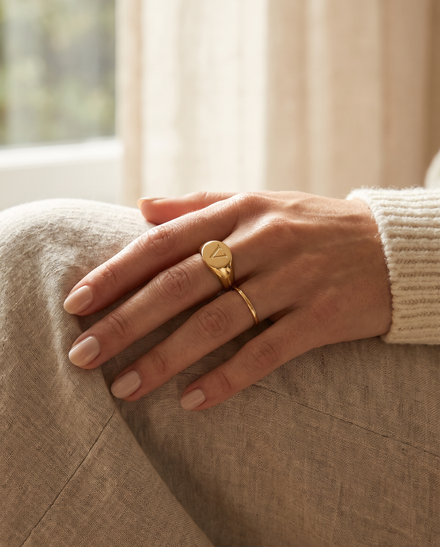 The Vesper signet ring worn on the hand