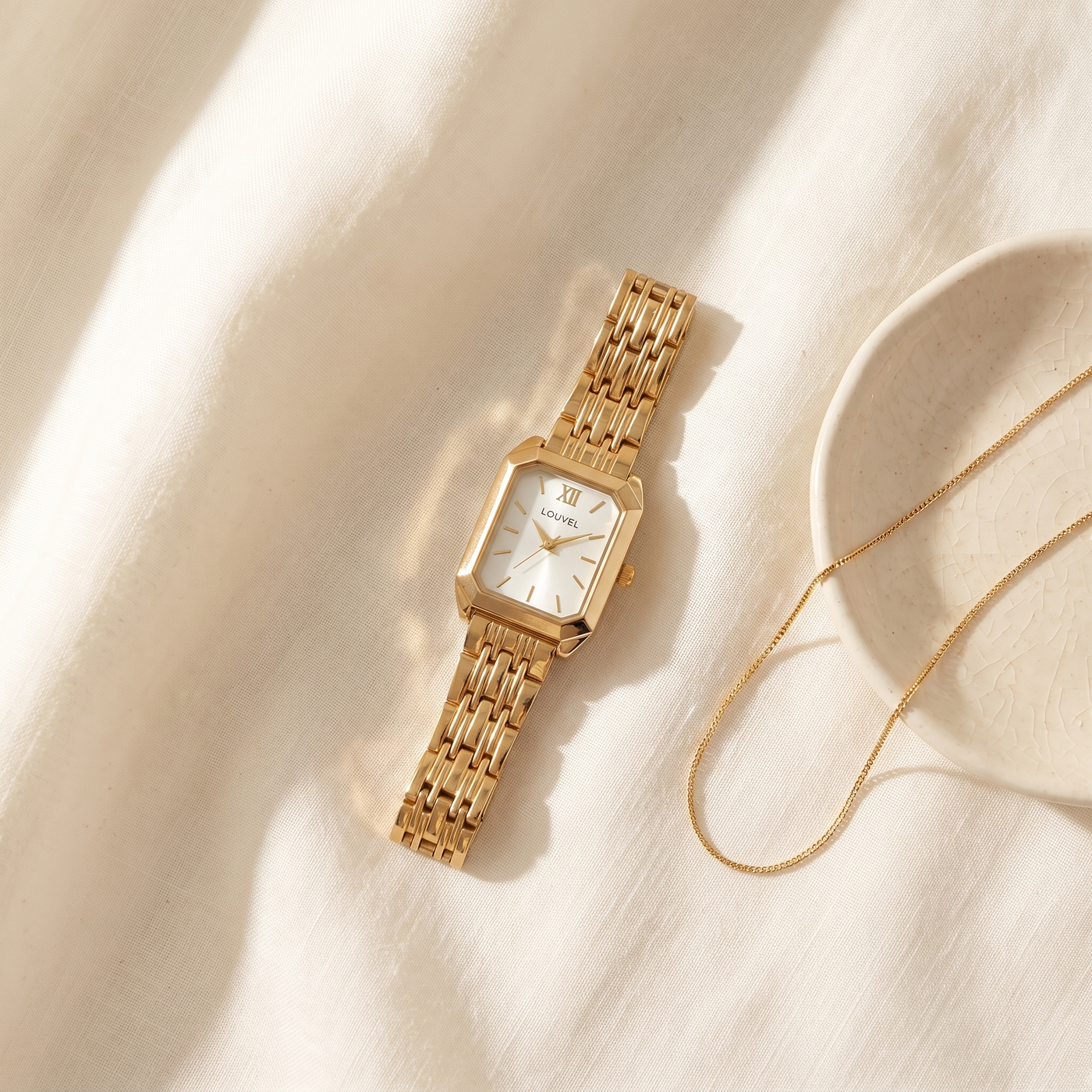 The Colette styled on ivory linen with a fine gold chain